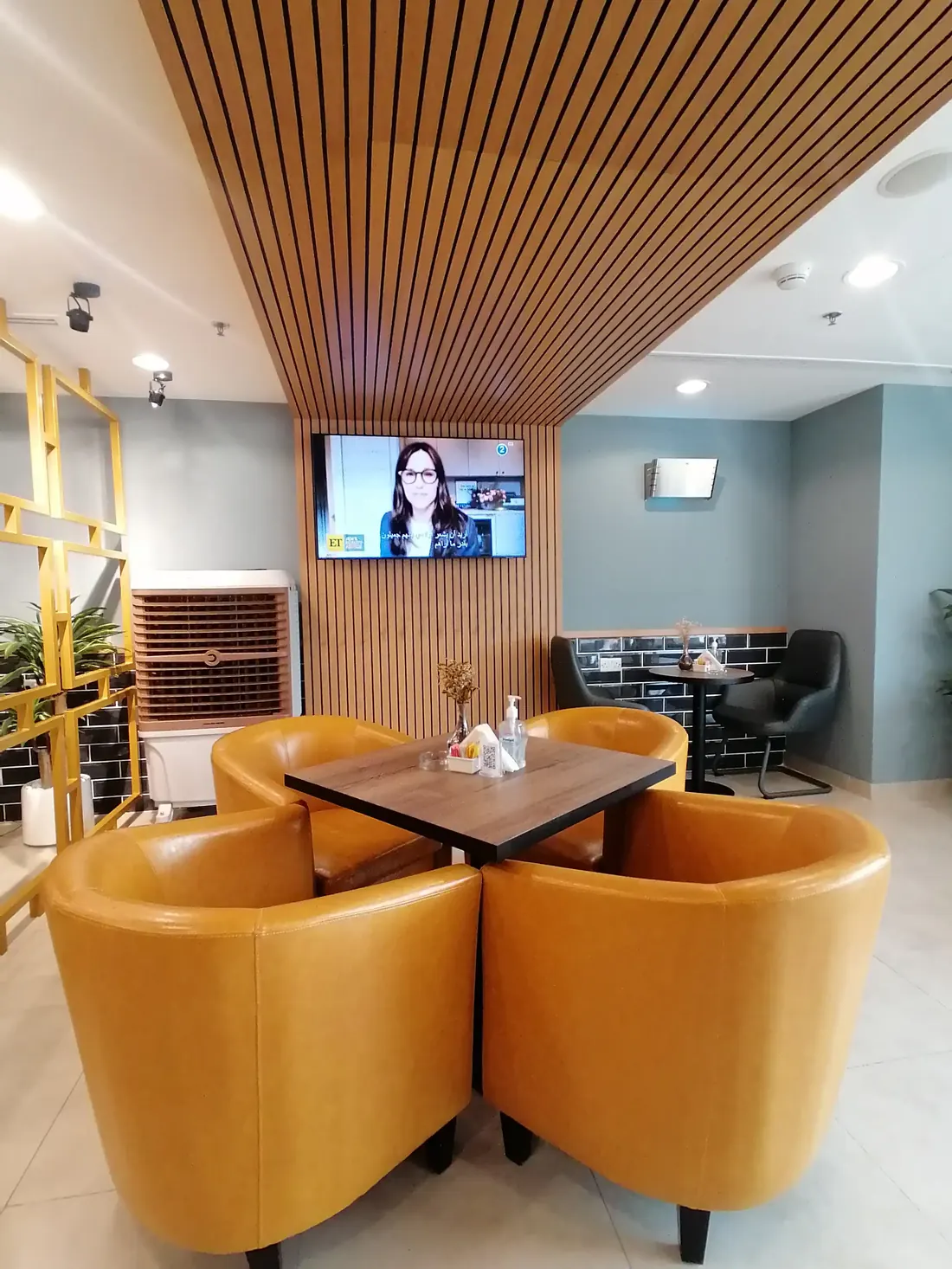 Yellow tub chairs and a round table