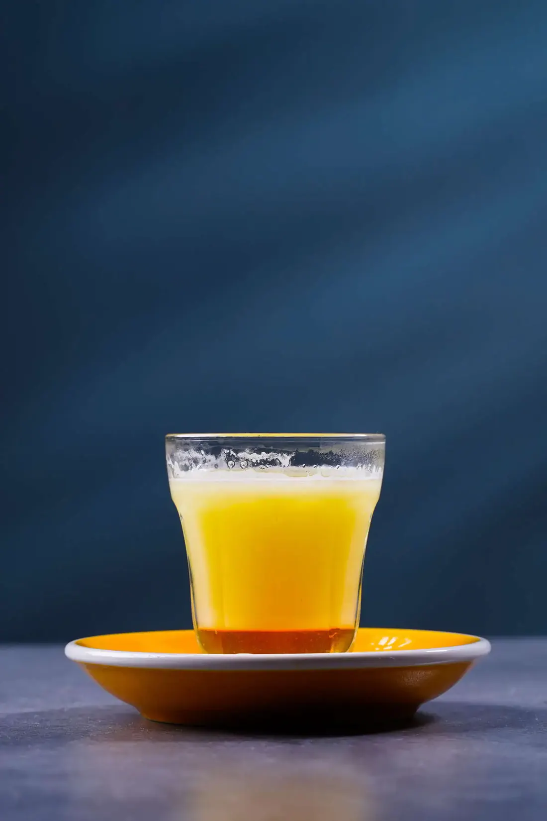 A cold drink on an orange saucer at Yellow Dot Cafe