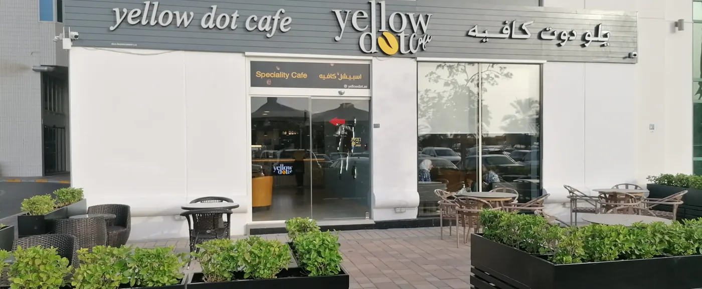 The Yellow Dot Cafe sign at Al Hana Tower